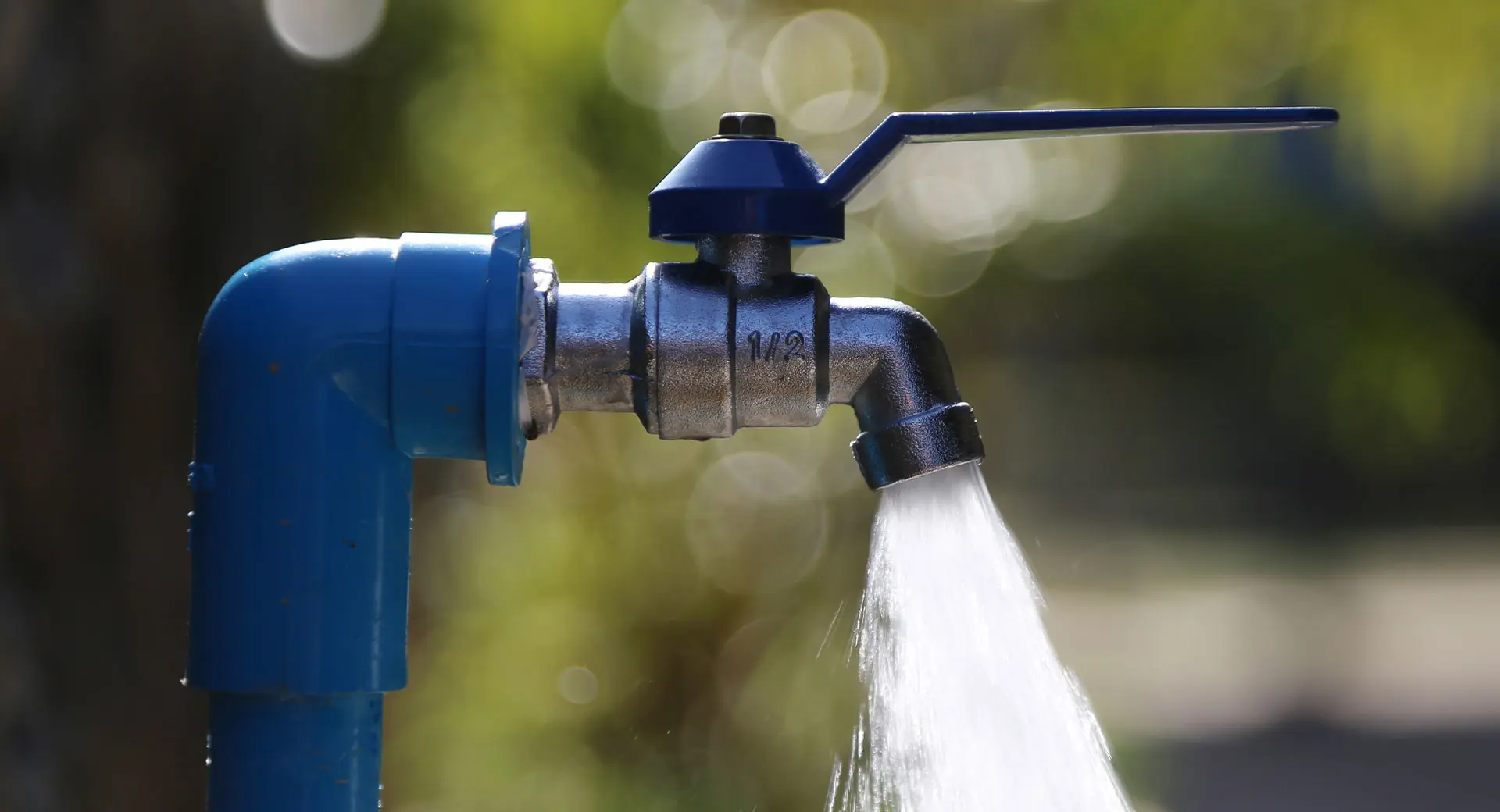 Water gushes from a blue standpipe 