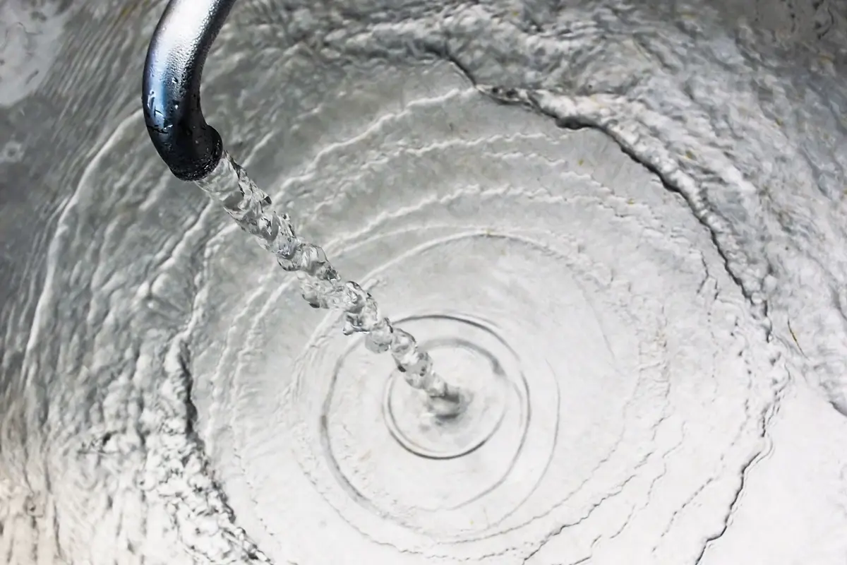 Clean water coming out of a tap into a sink