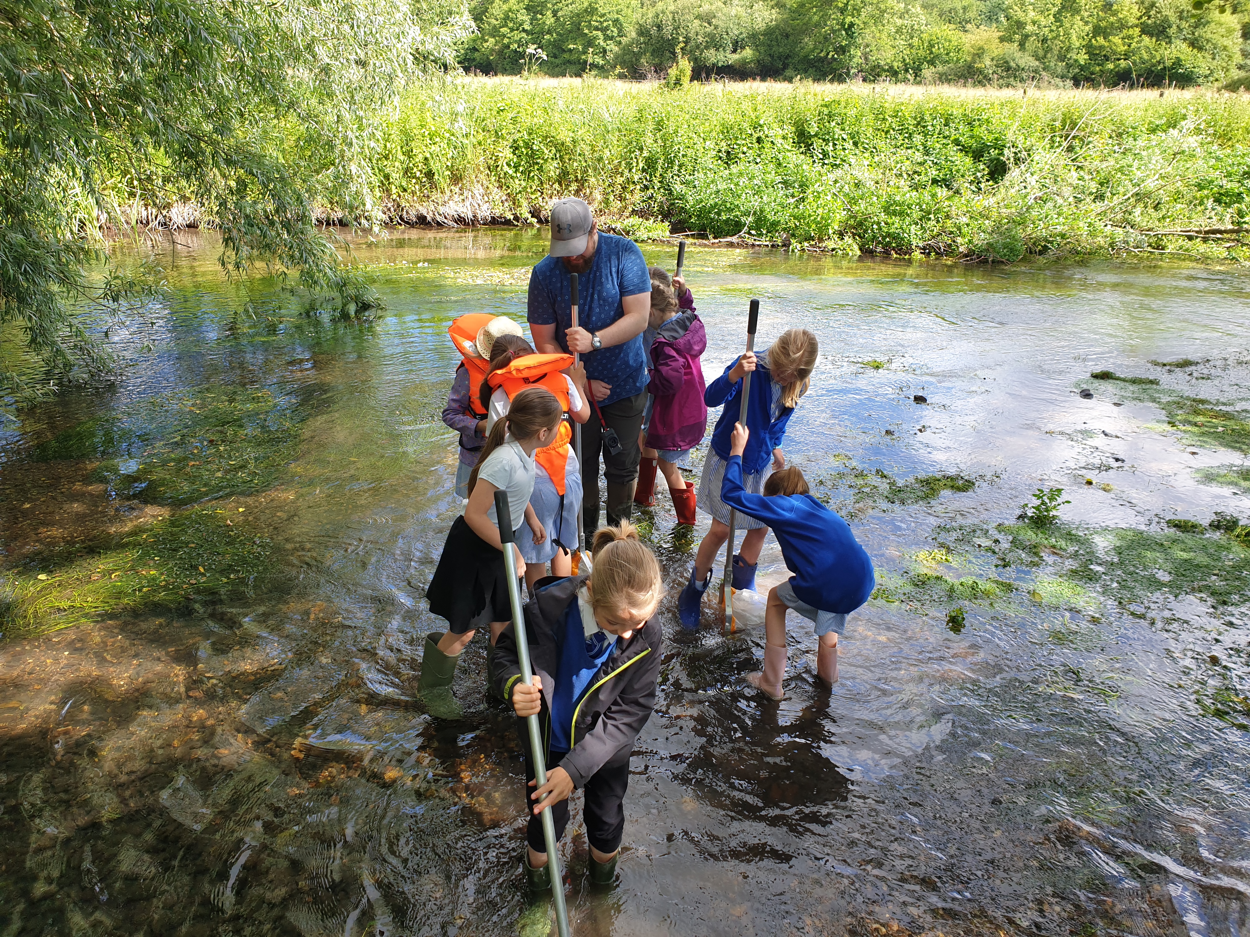 children learning about water outdoors in a river