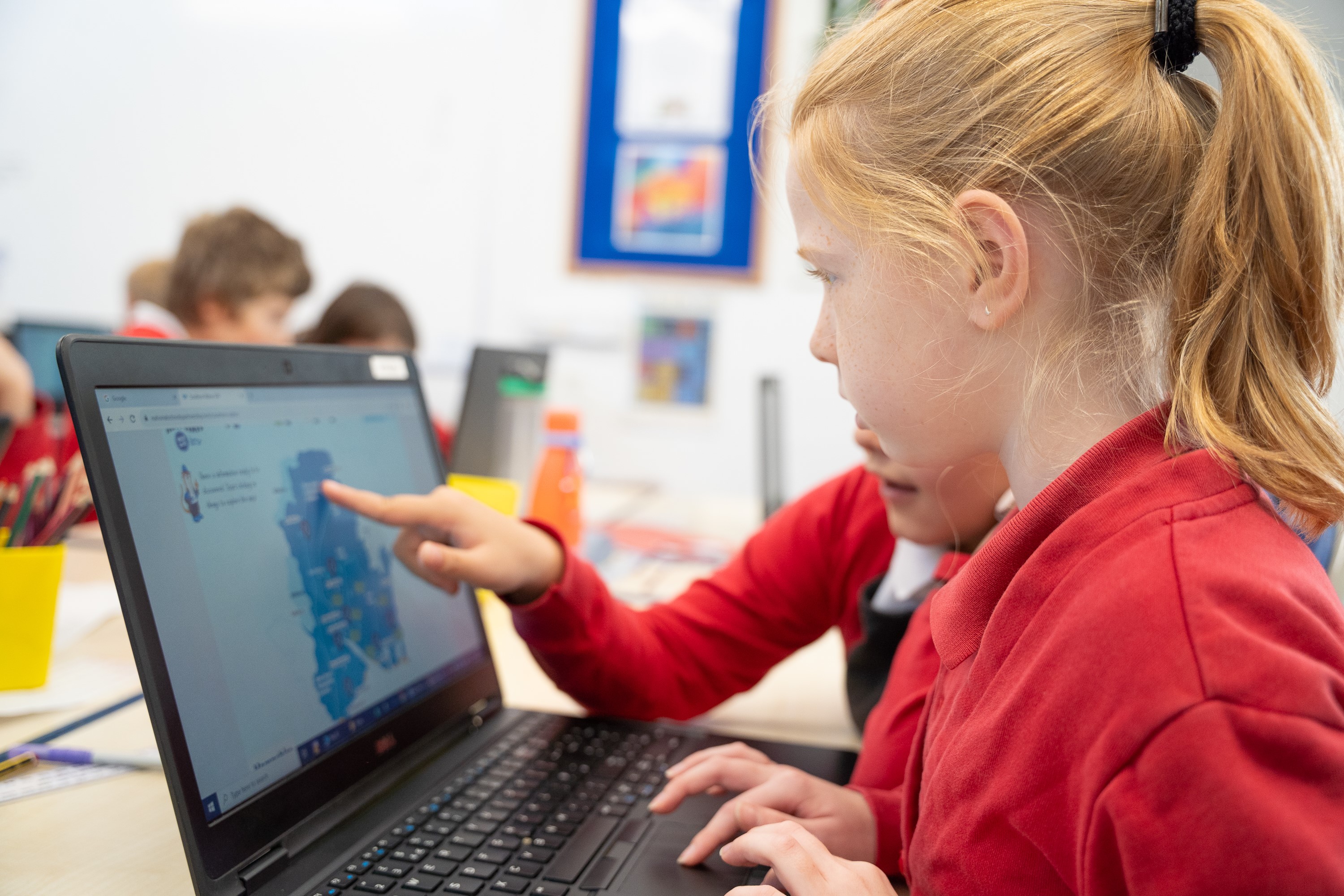 two children using new wave educational resources on a laptop