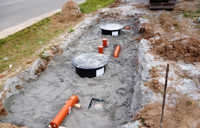 A soakaway being constructed by the side of a road