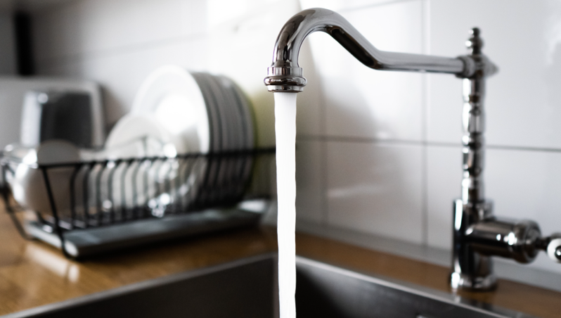 A tap running water into the sink