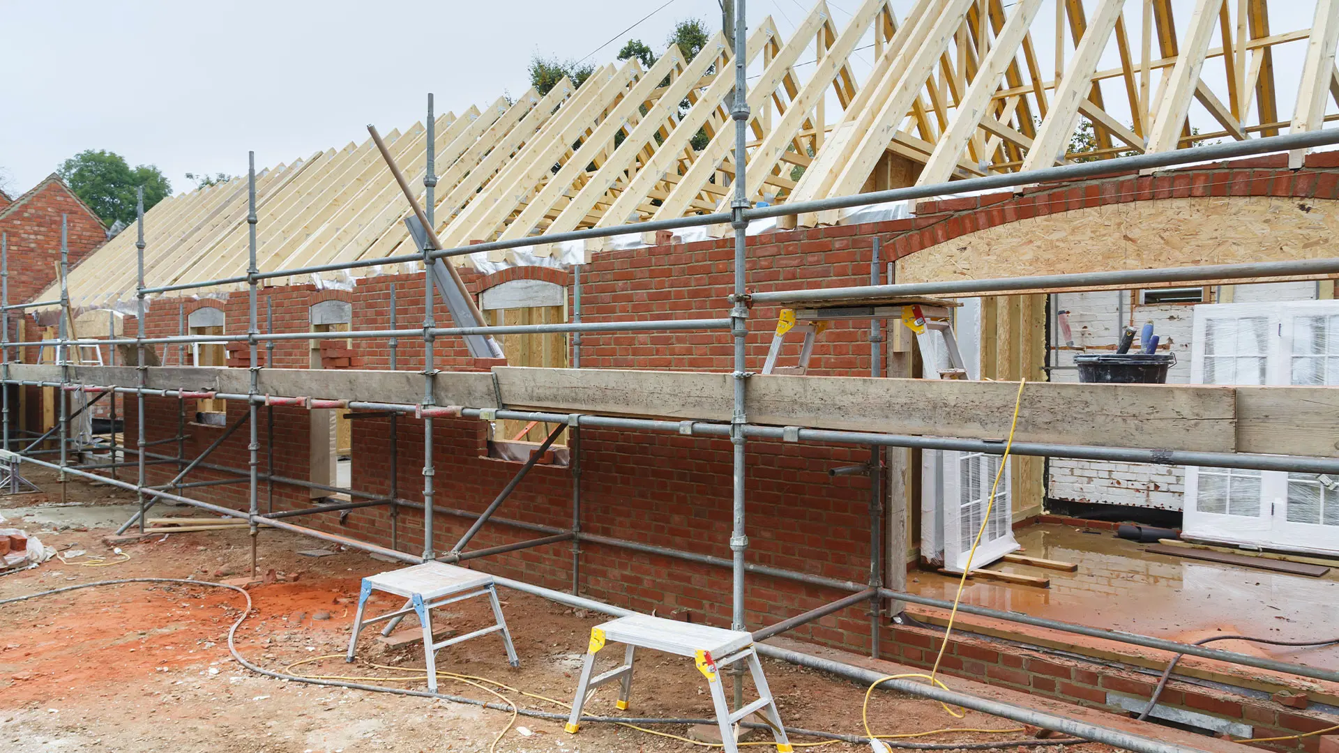 Progress shot of red brick extension surrounded by scaffolding