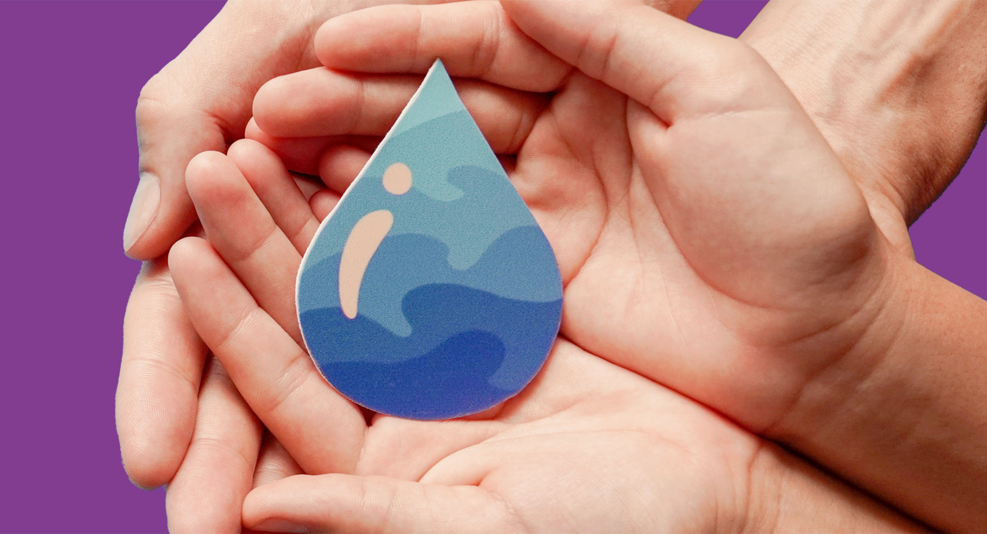 People holding a cutout of a water droplet