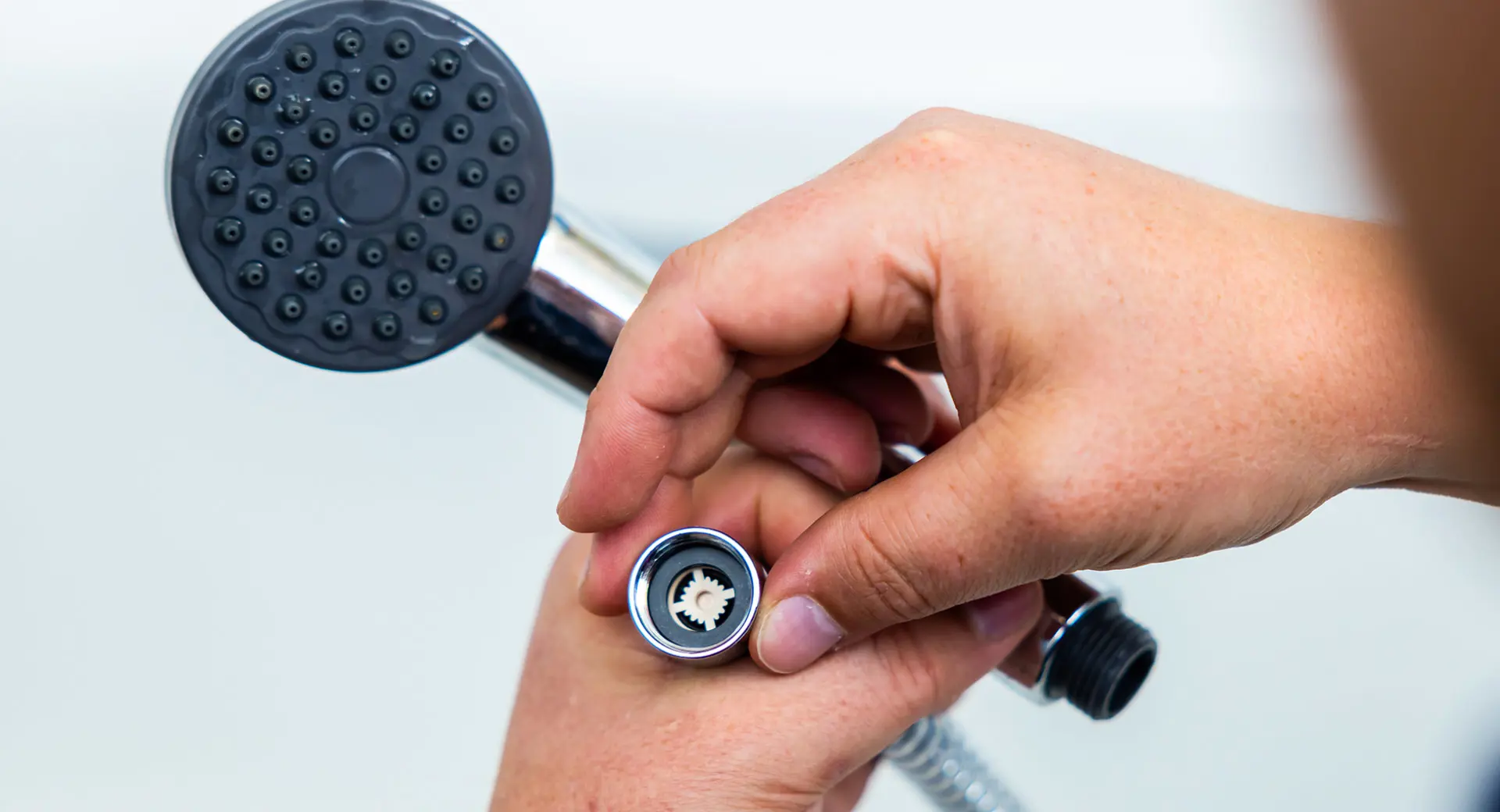 Person replacing a shower head